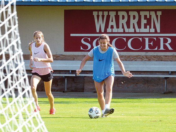 Warren players with sign.jpg